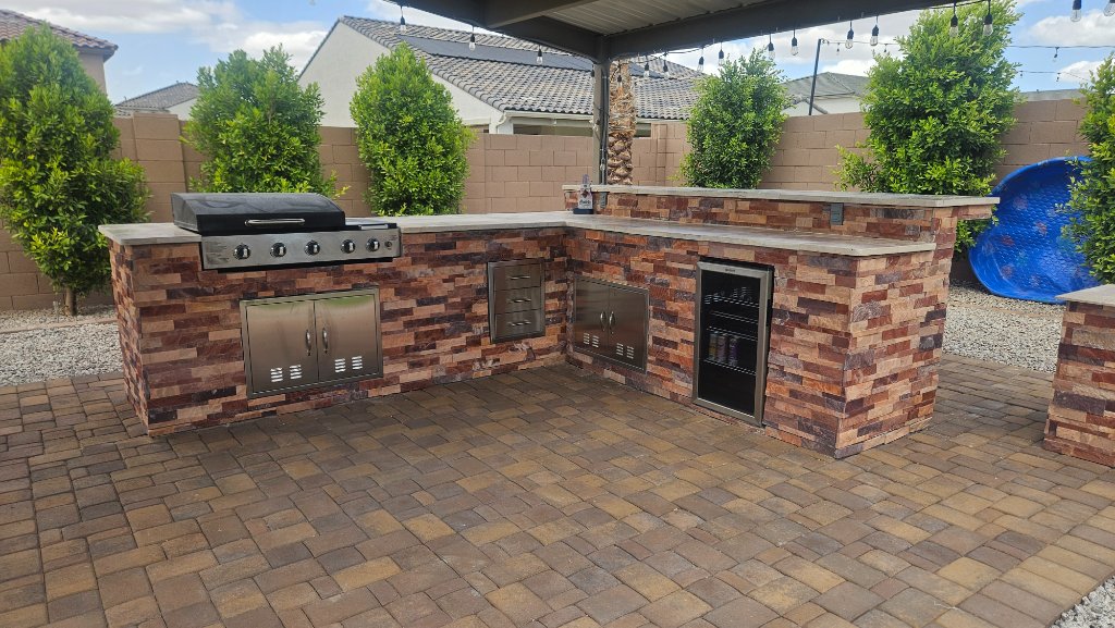 Outdoor kitchen with stone facade and built-in grill