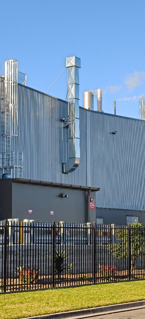 Galvanized duct stack and weather cowl running up the exterior wall