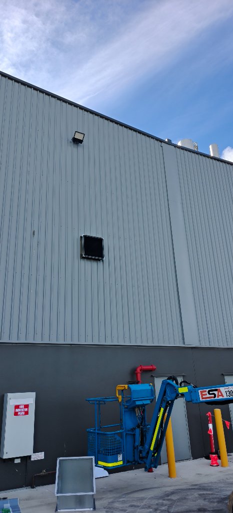 The duct run exiting the exterior wall of the workshop