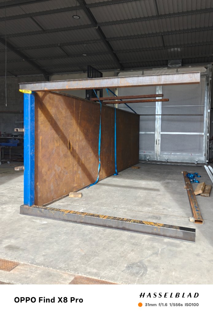 Heavy steel sections lifted and positioned by forklift