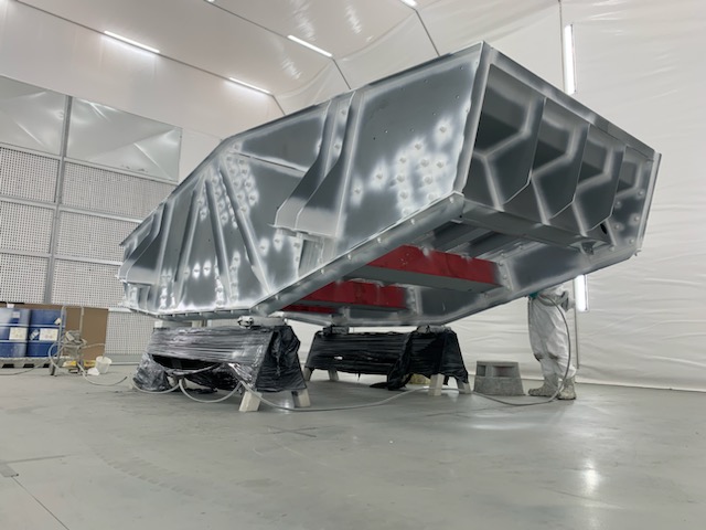 Mining screen being coated inside booth