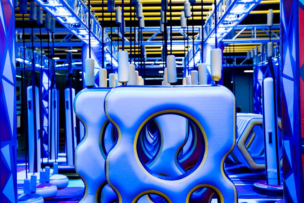 Indoor obstacle course with suspended light-blue padded cubes and yellow trim at Lululand