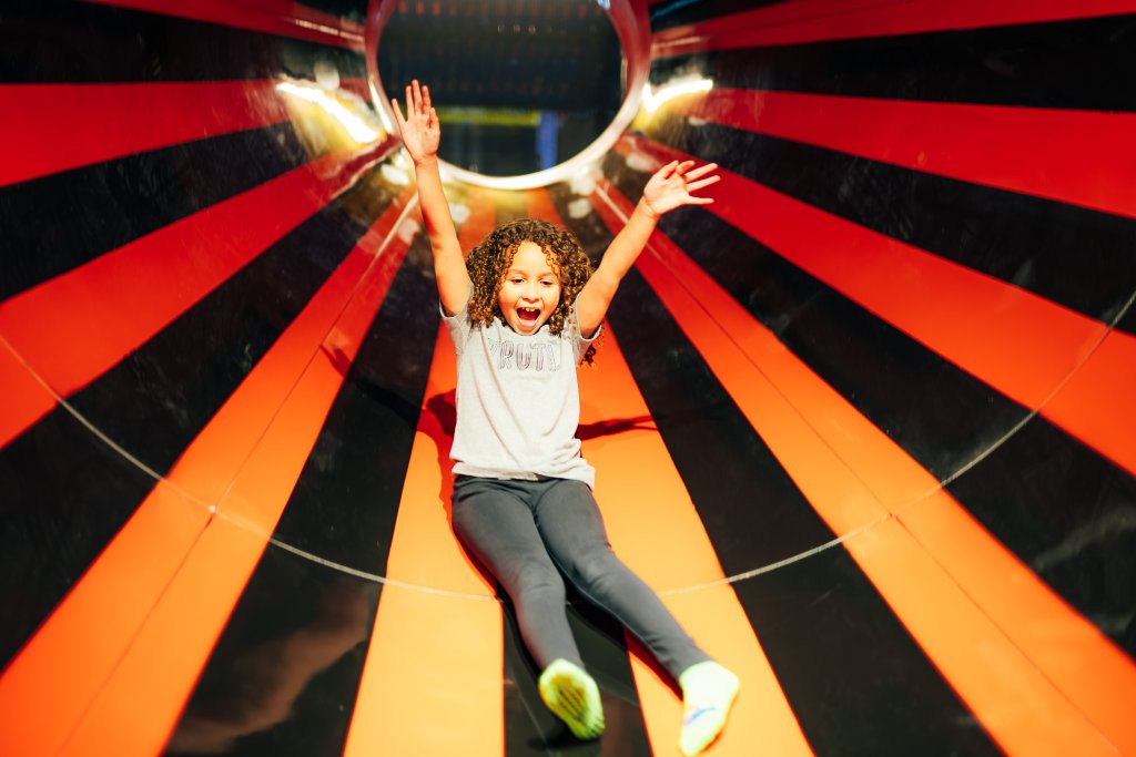 Neon-lit spiral slide attraction at Lululand Adventure Park