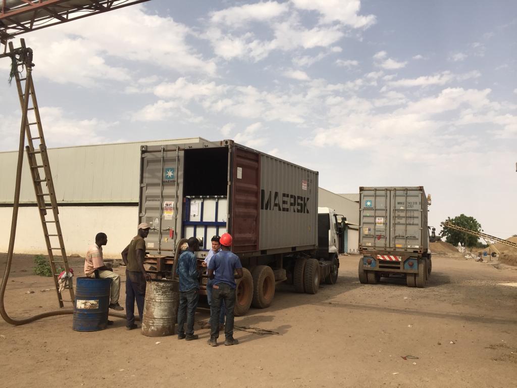 Niofar Capital discussing project requirements with stakeholders on site, beside the truck