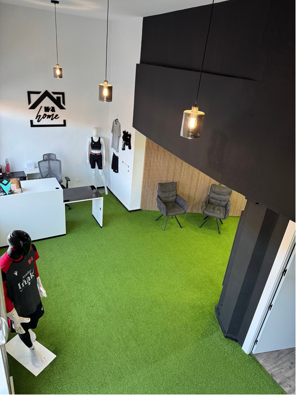 Interior de la tienda M2A Home con césped artificial y exposición de productos