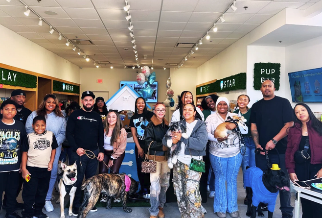 Puptqe community members and their dogs celebrating a birthday at the Pup Bar