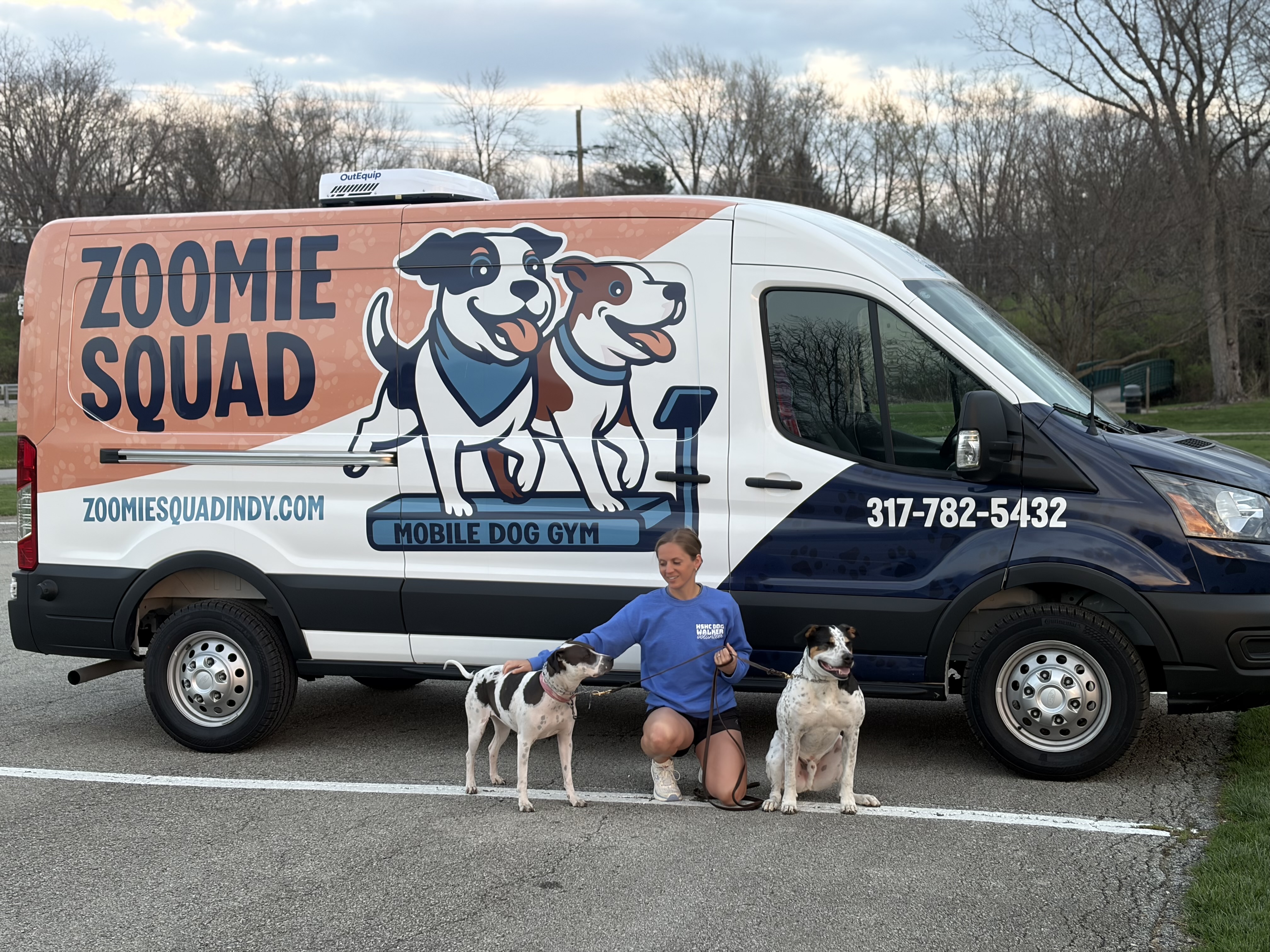 Caregiver interacting with dog on trail