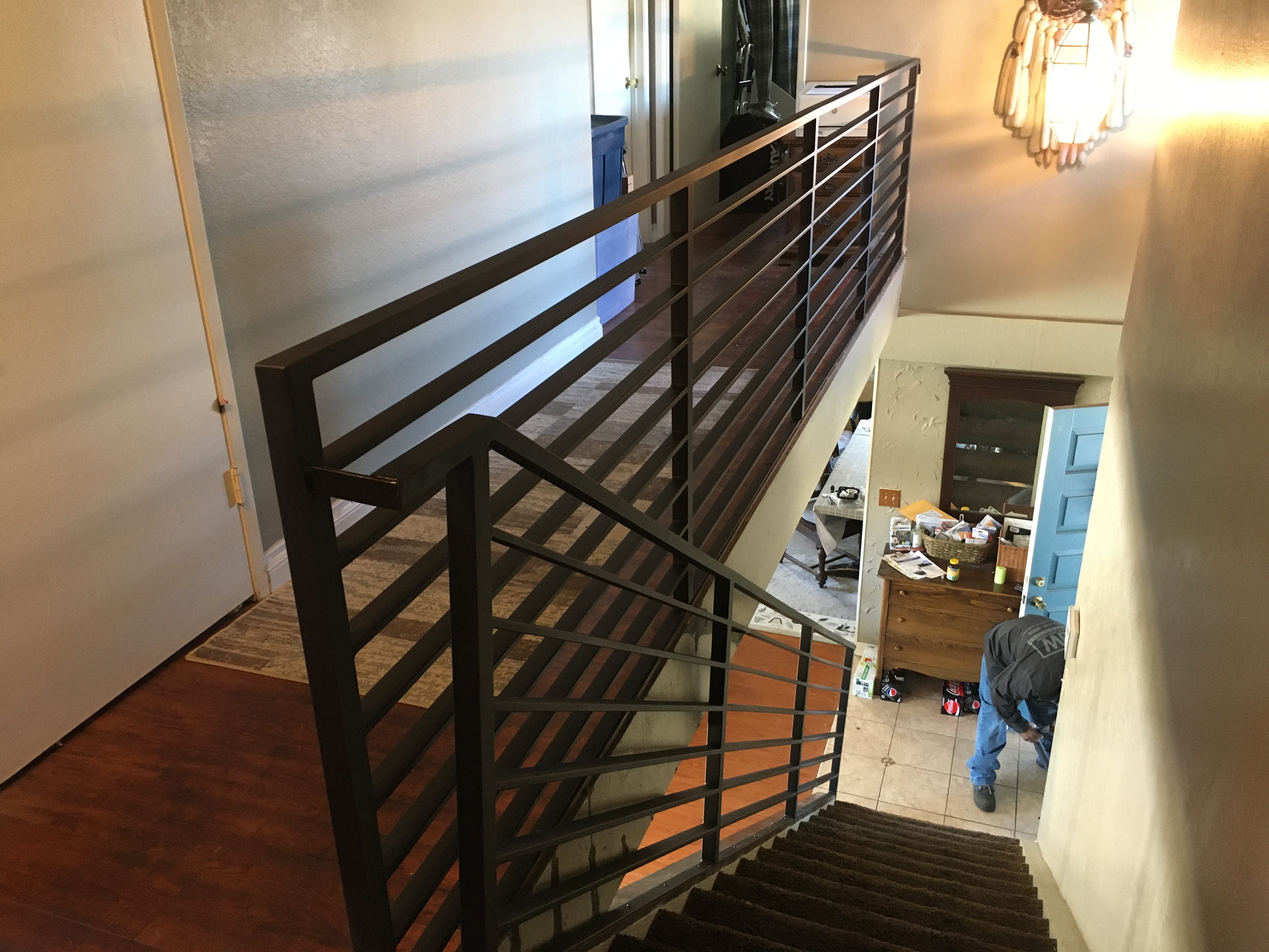 Modern Horizontal Iron Stair Railing on Grey Steps