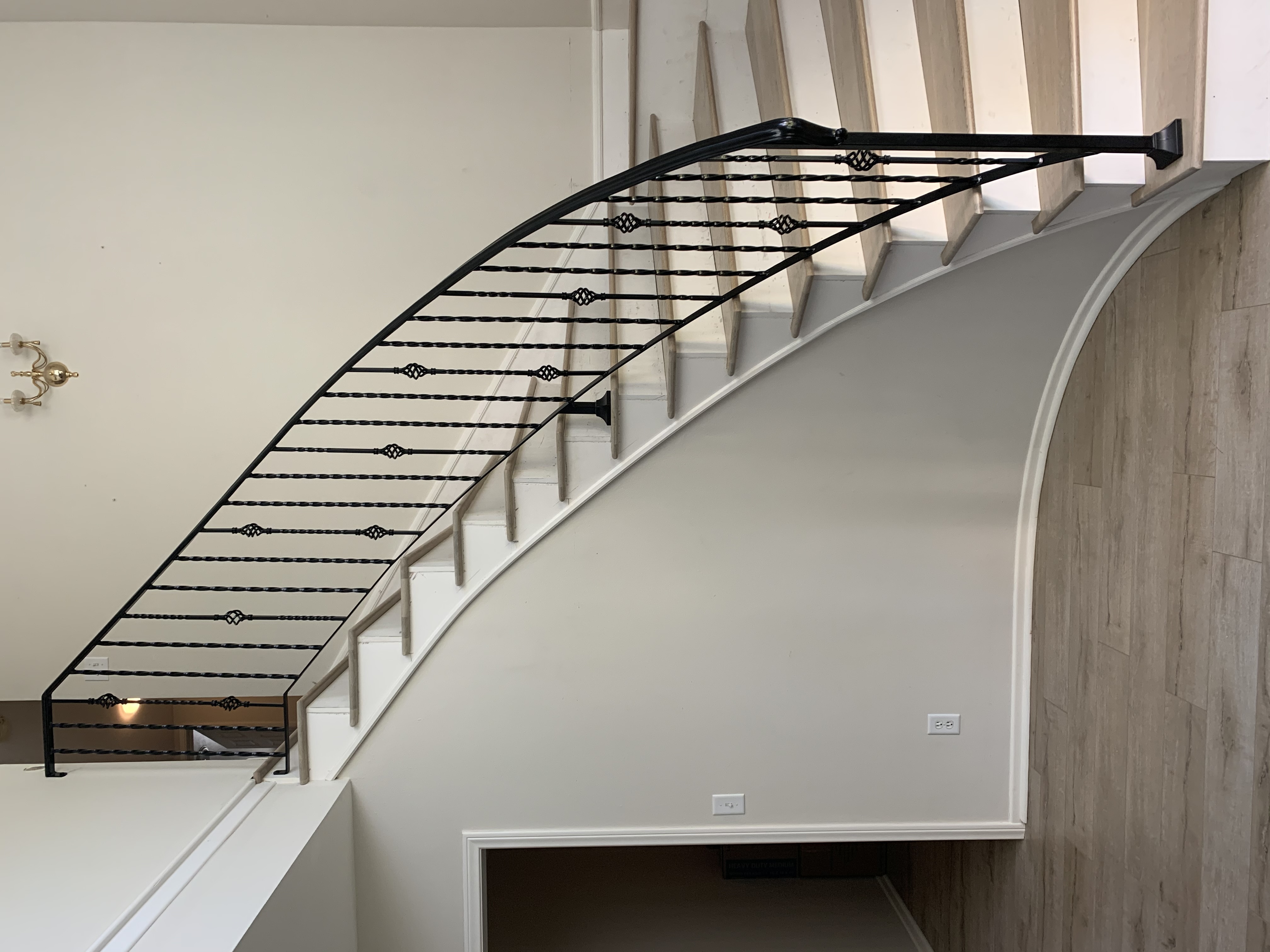 Curved Staircase with Scrollwork Accent Railing