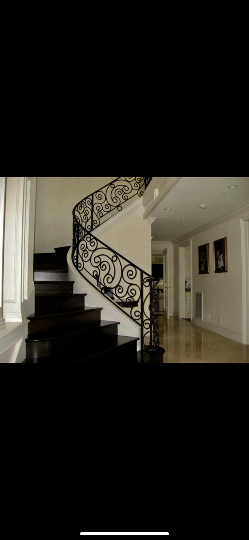 Scrollwork Curved Staircase Railing in Grand Foyer