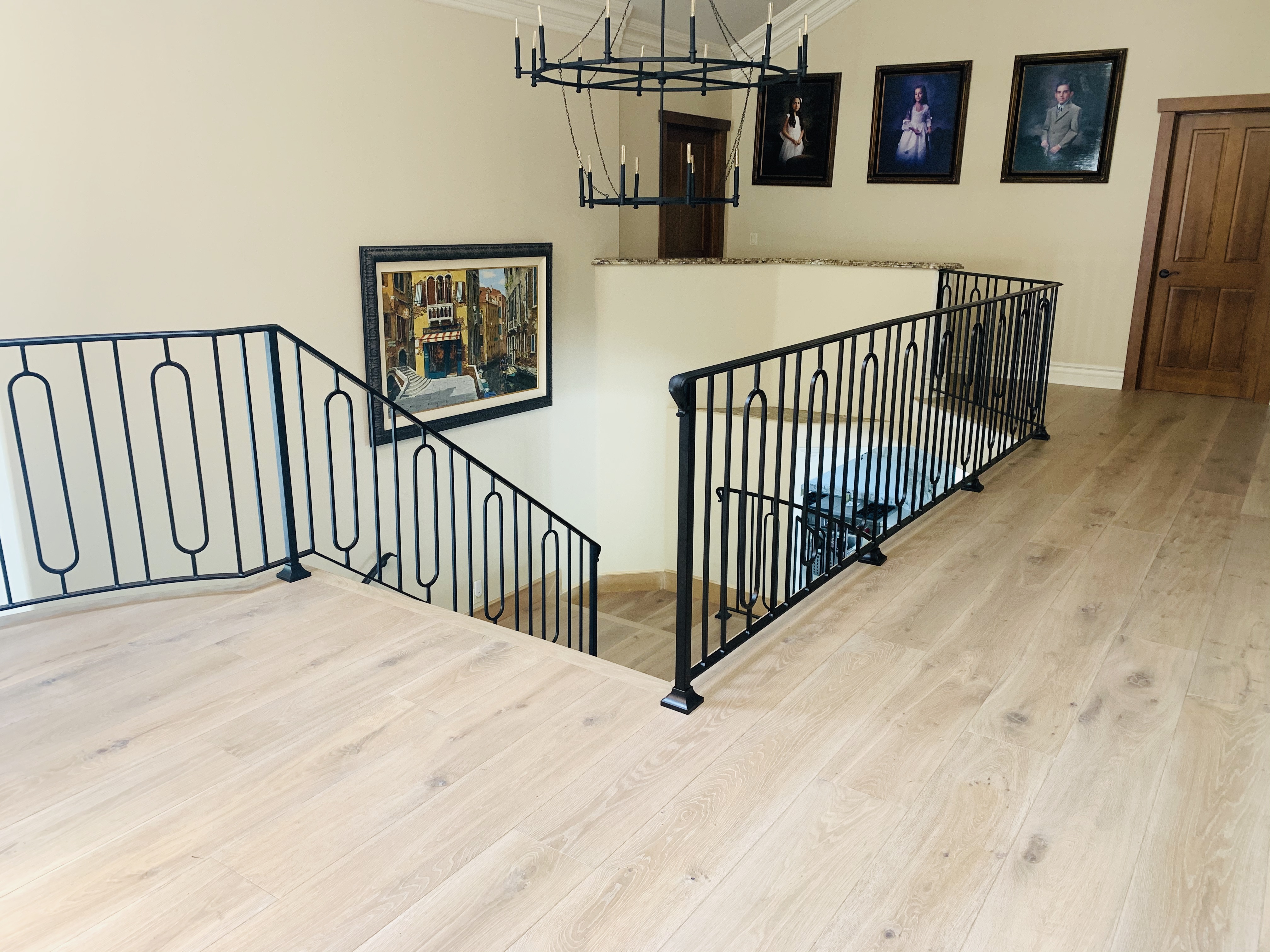 Iron Railing with Scrollwork Accent on Marble Landing