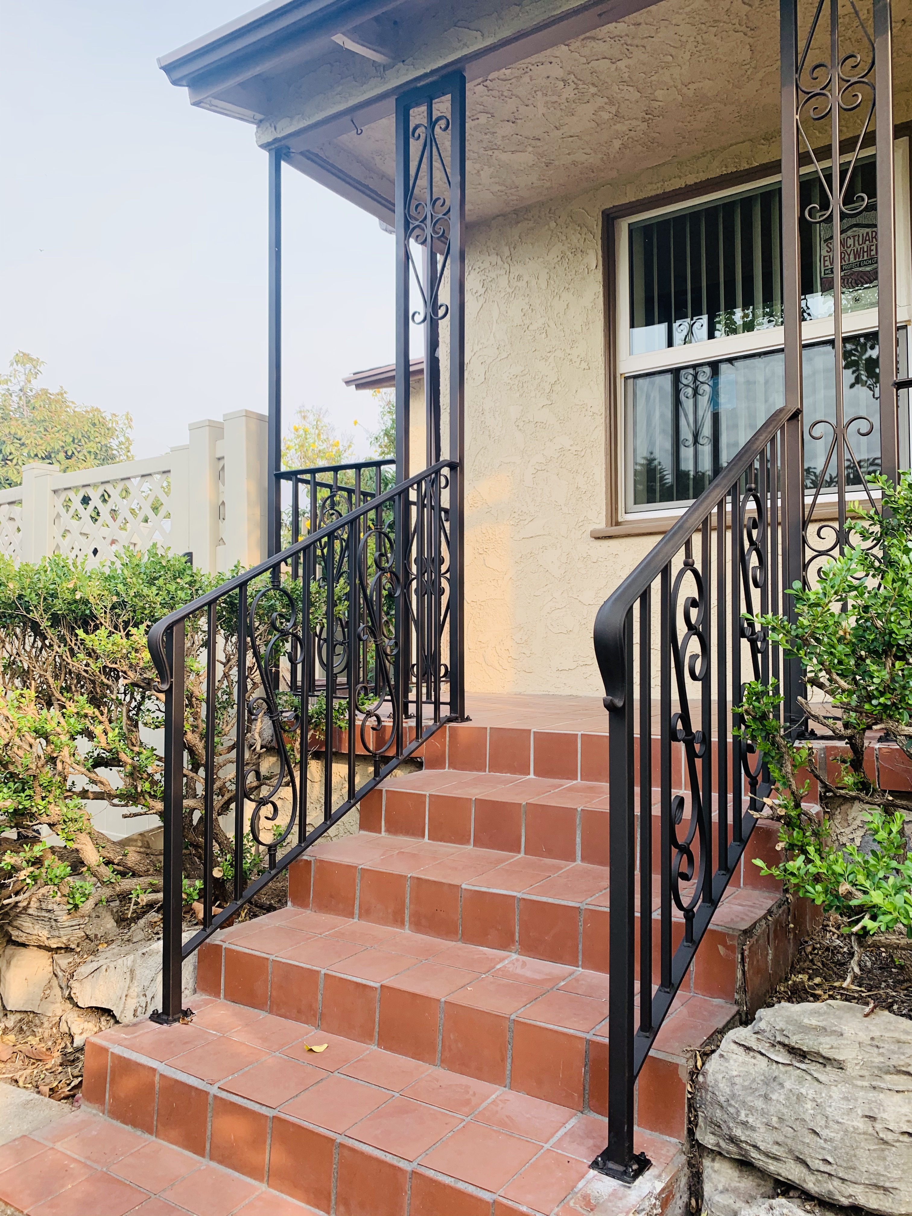 Scrollwork Stair Railing on Terracotta Steps