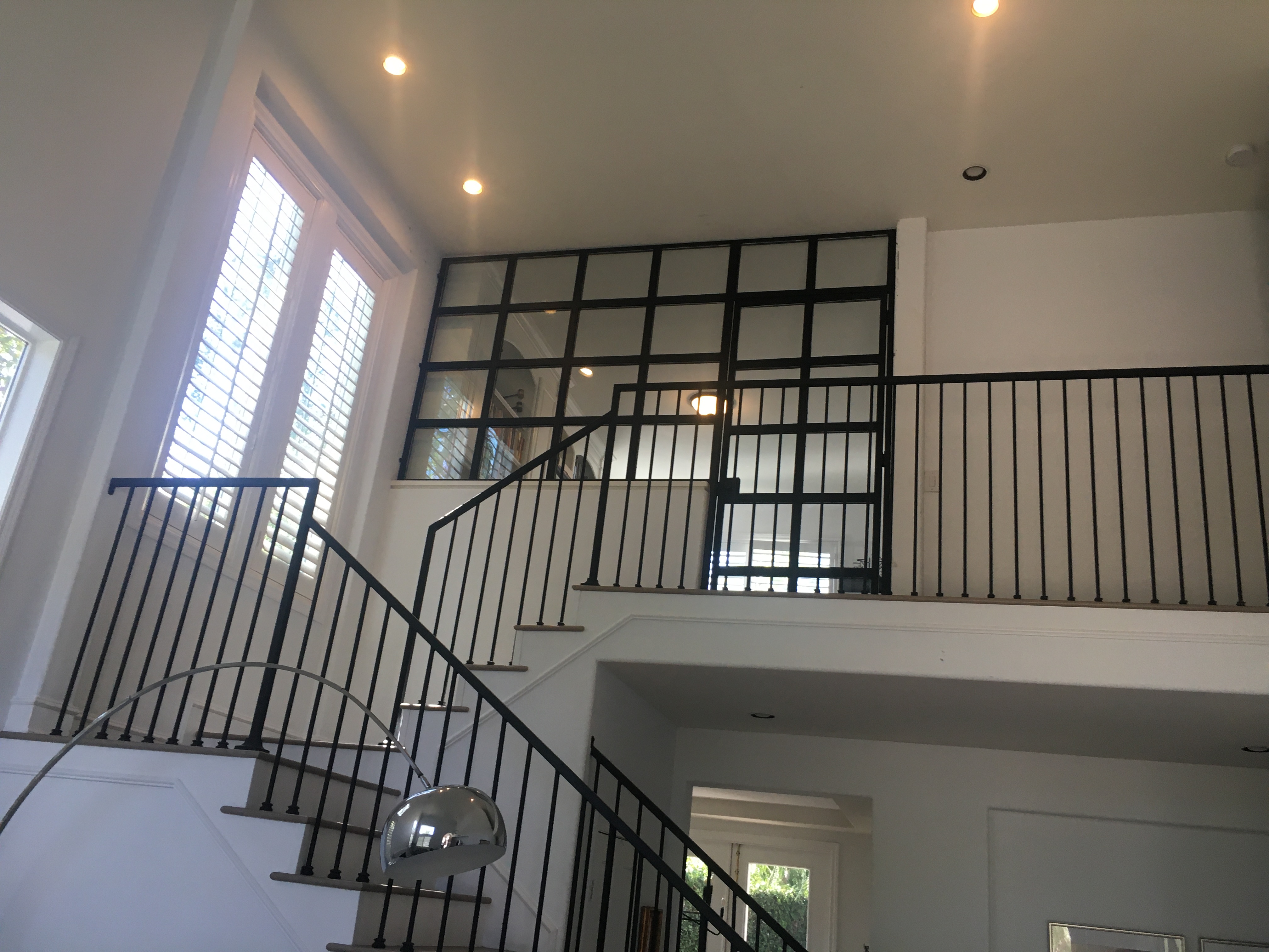 Dark Iron Curved Staircase with Ornate Baluster Railing