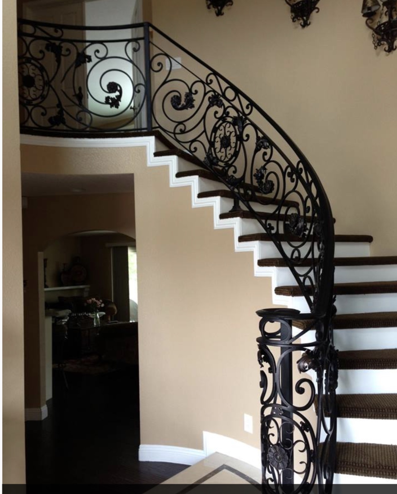 Curved Staircase with Ornate Scrollwork Railing