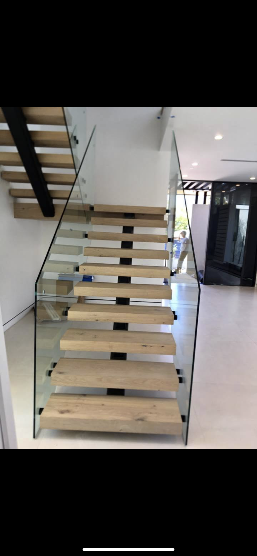 Iron Railing with Scrollwork Accent Panels on Marble Steps