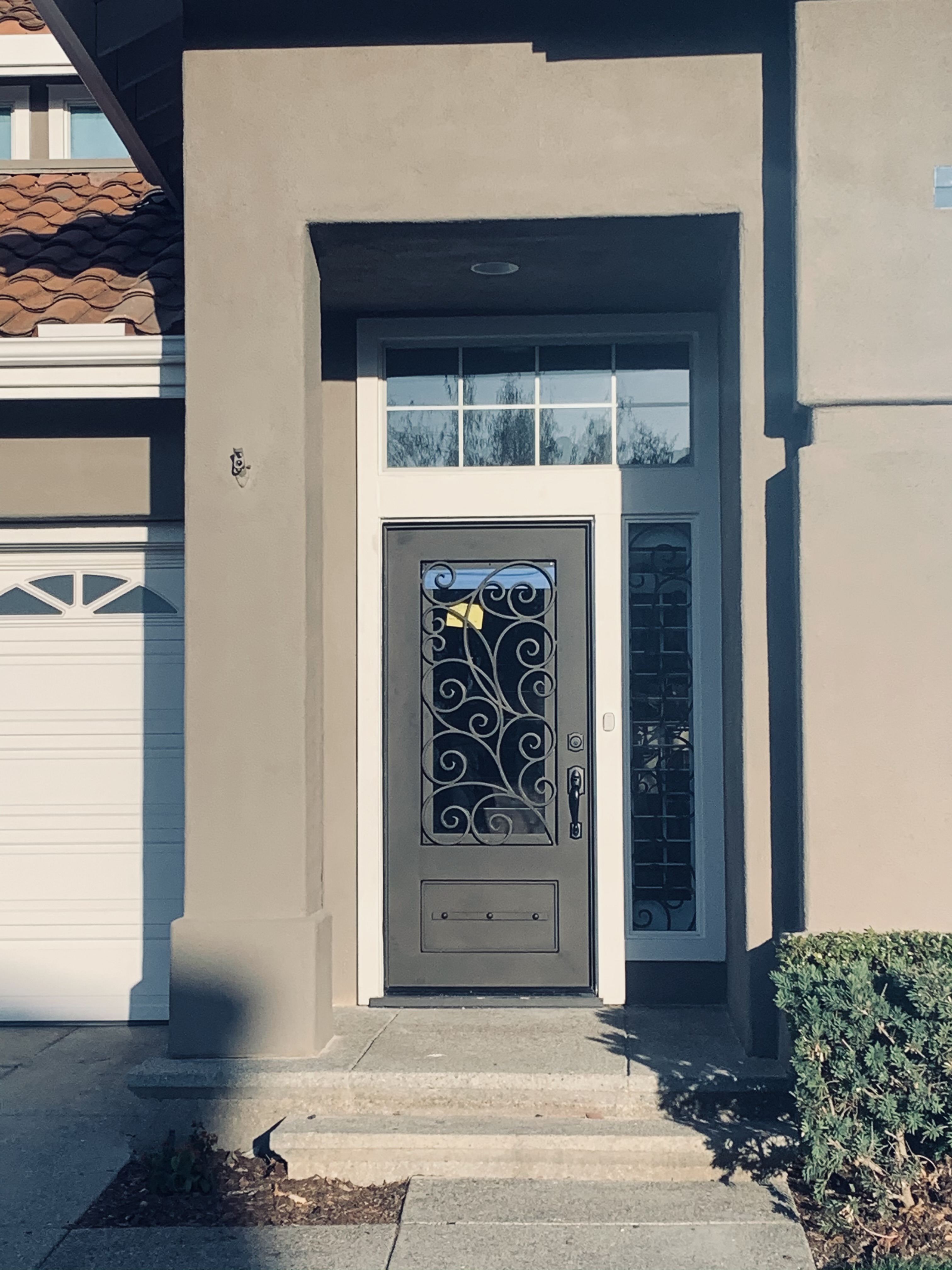 Grand Scrollwork Double Iron Door with Sunburst Transom
