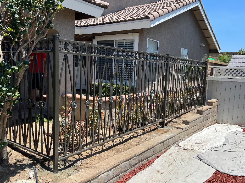 New geometric wrought iron fence with diamond pattern and rosette accents installed in Yorba Linda by Xtreme Iron Work