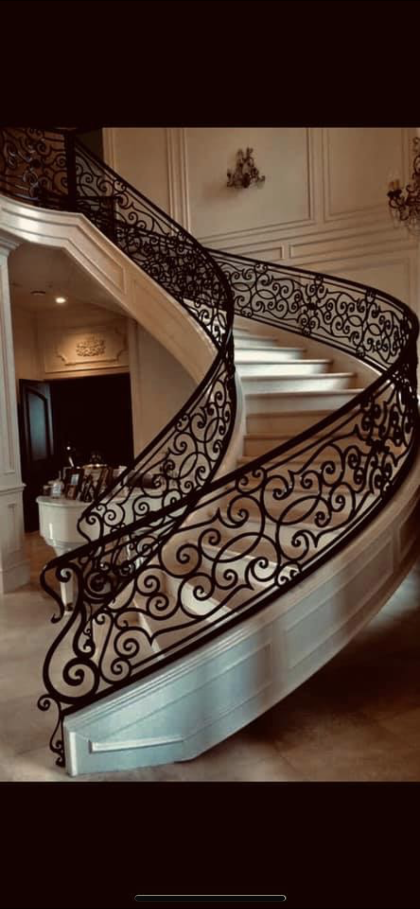 Grand Curved Staircase with Scrollwork Balustrade