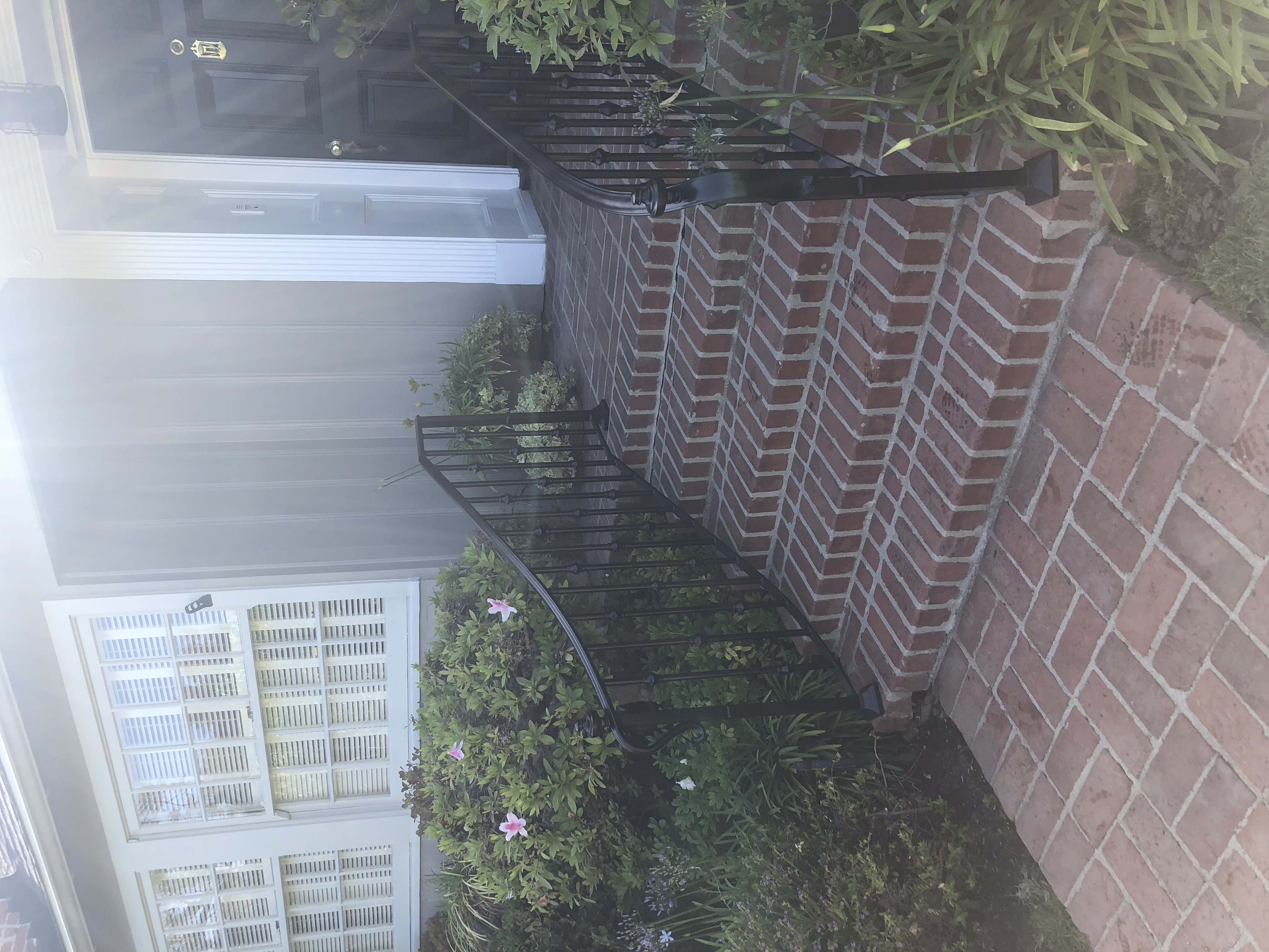 Iron Front Step Railing on Brick Walkway