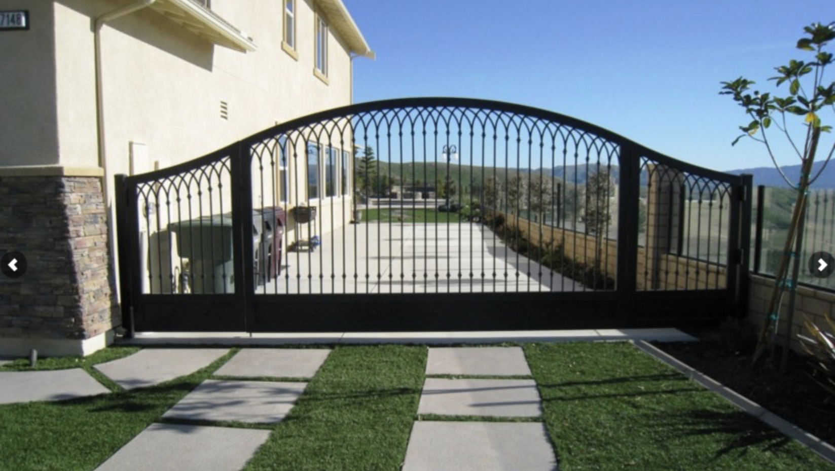 Arched Iron Driveway Gate with Scrollwork