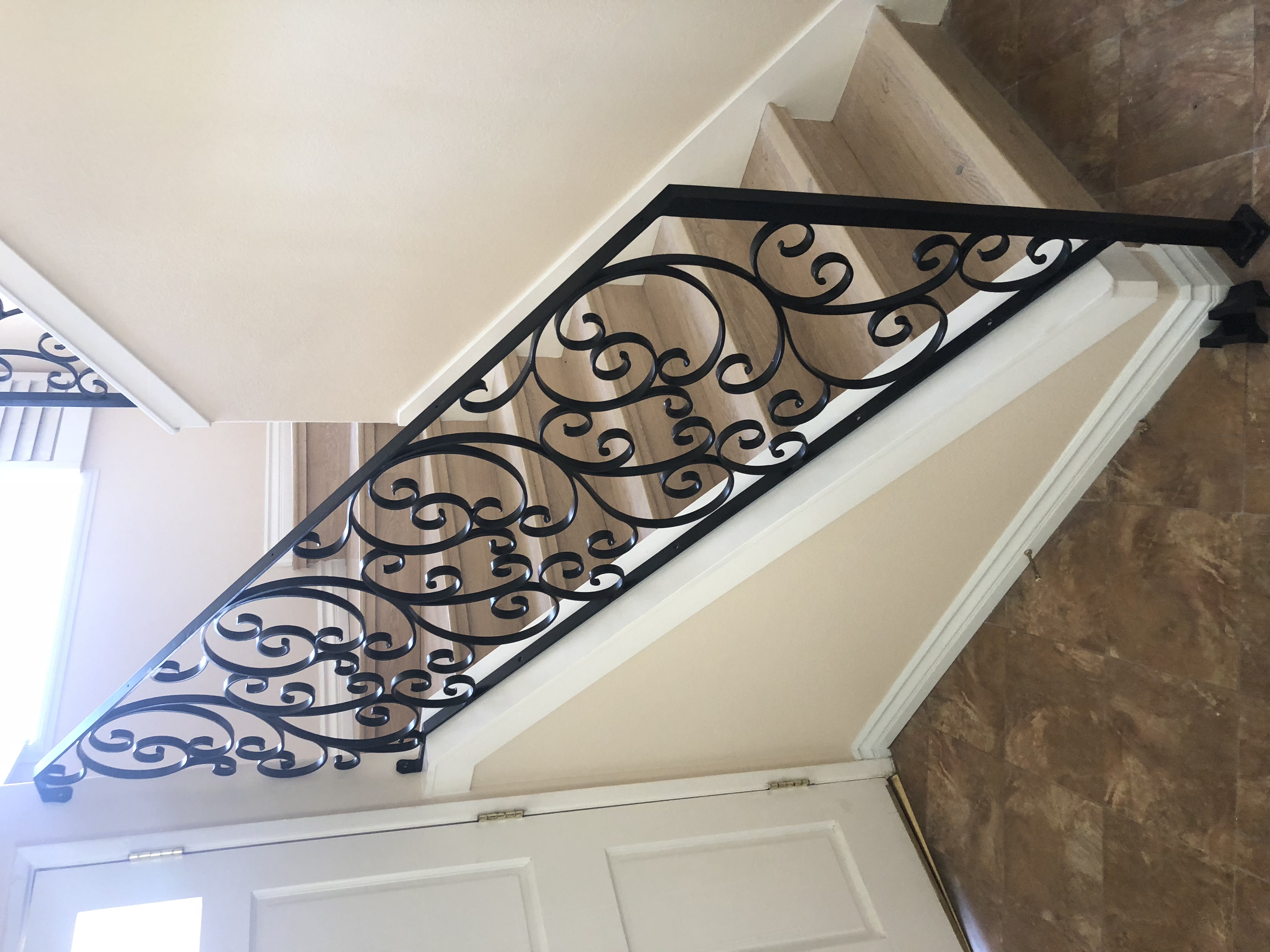 C-Scroll Iron Stair Railing on Marble Steps
