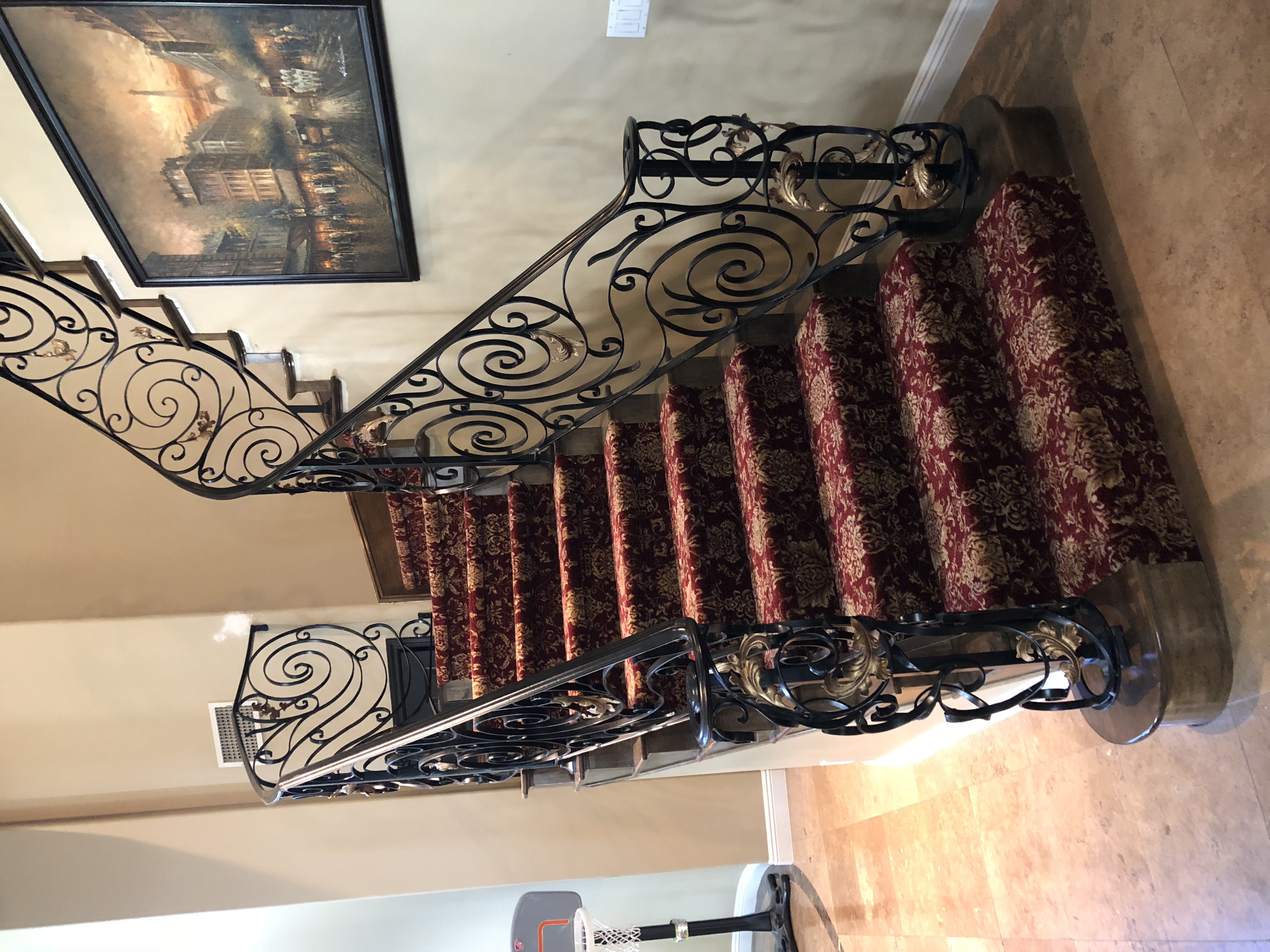 Scrollwork Stair Railing on Red Damask Carpet