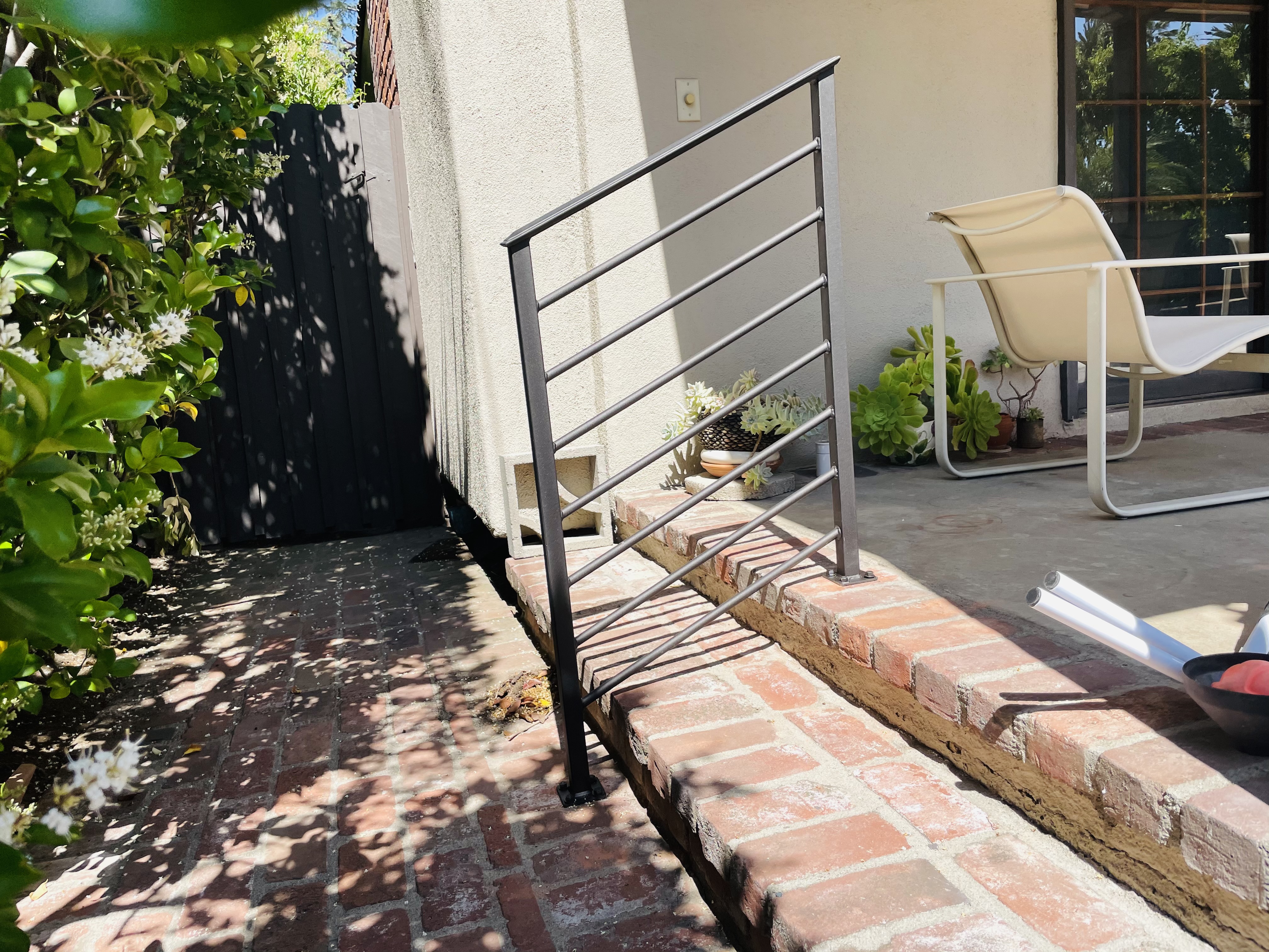Scrollwork Stair Railing on Brick Steps