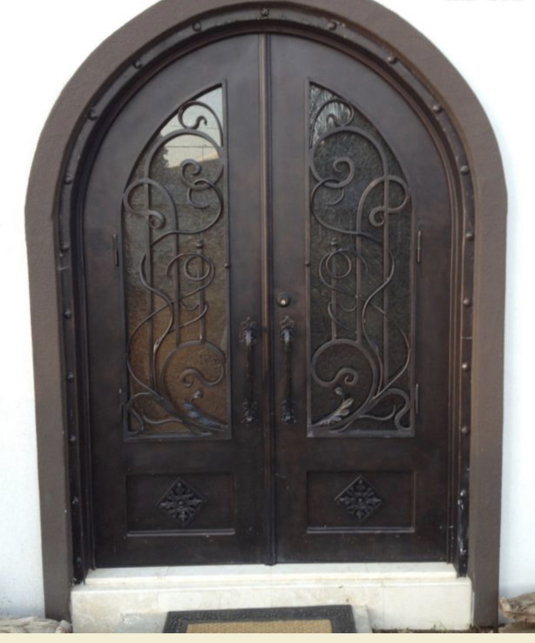 Arched Double Iron Entry Door with Scrollwork