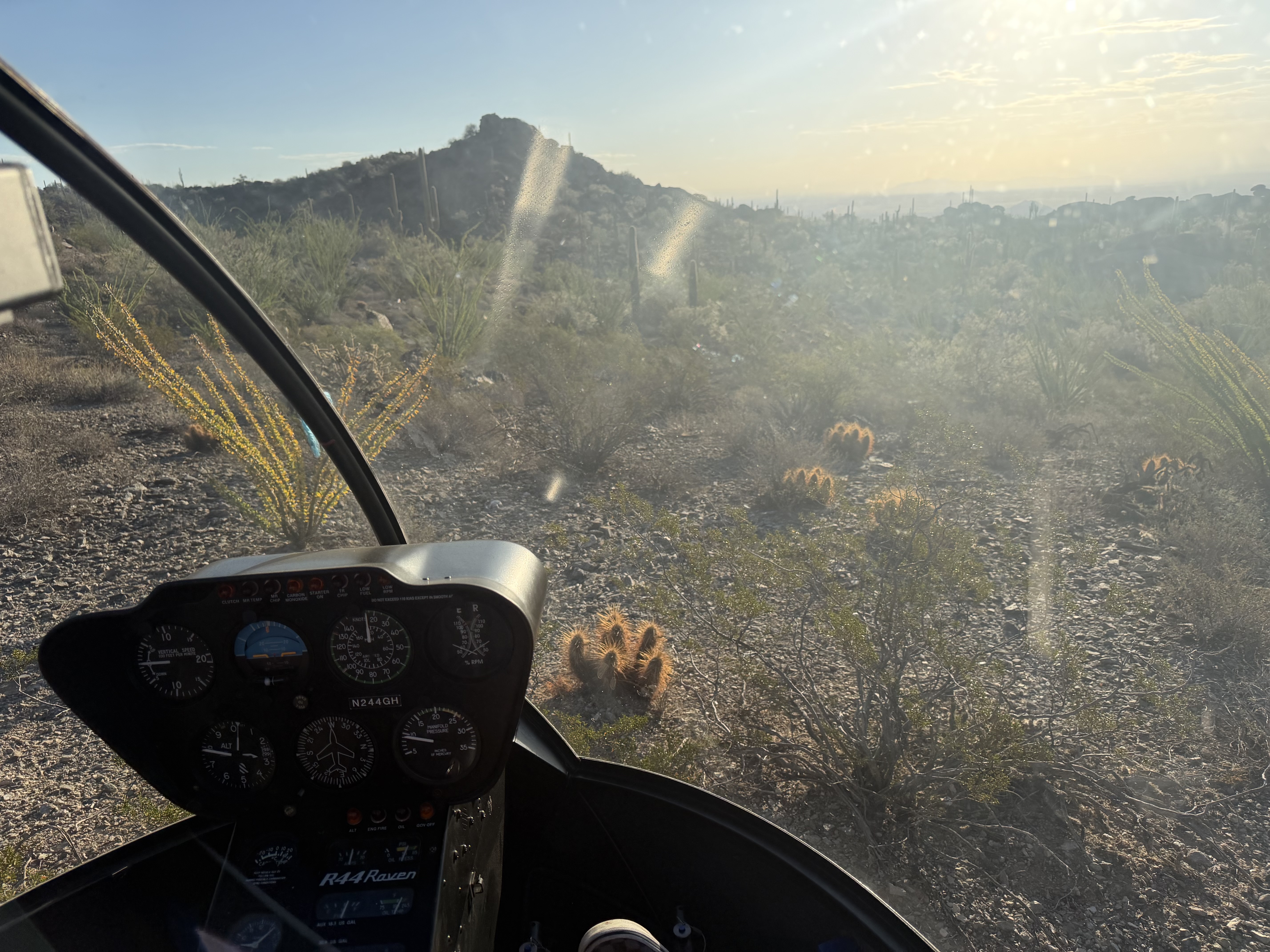 Cockpit view from a Robinson R44 helicopter over the desert