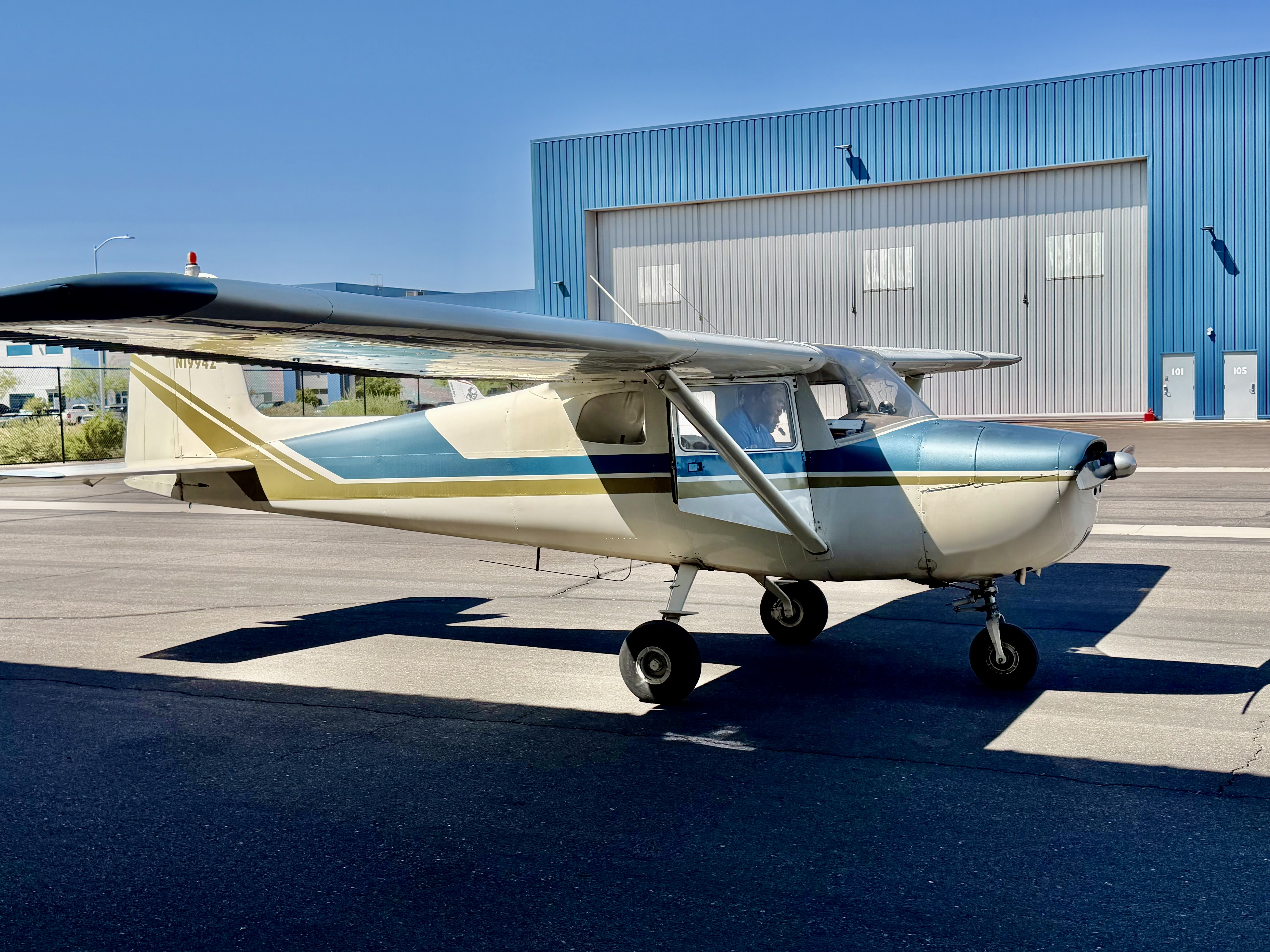 Cessna 150 high-wing trainer parked on the ramp