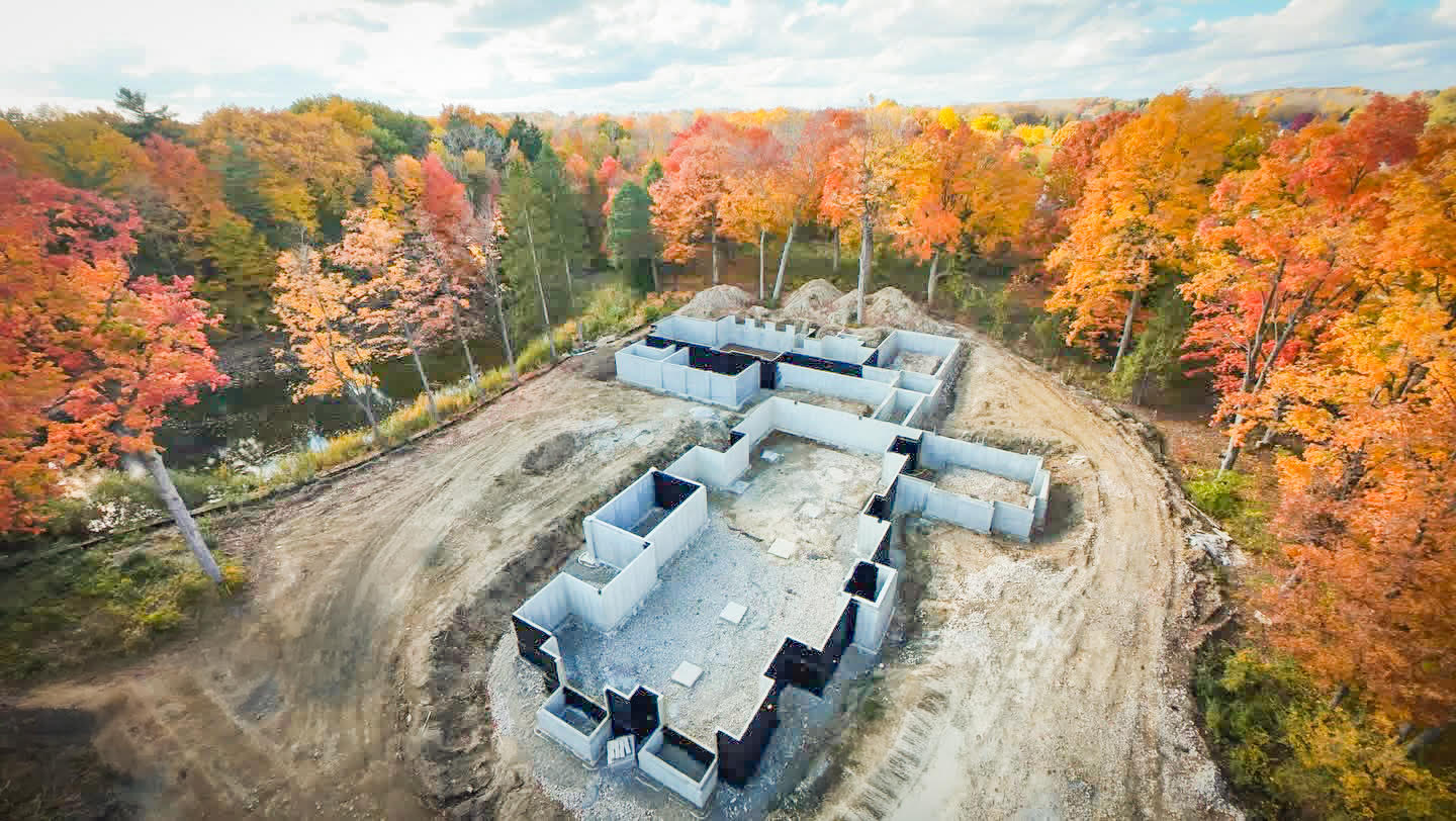 J&R Concrete foundation site surrounded by New England autumn foliage