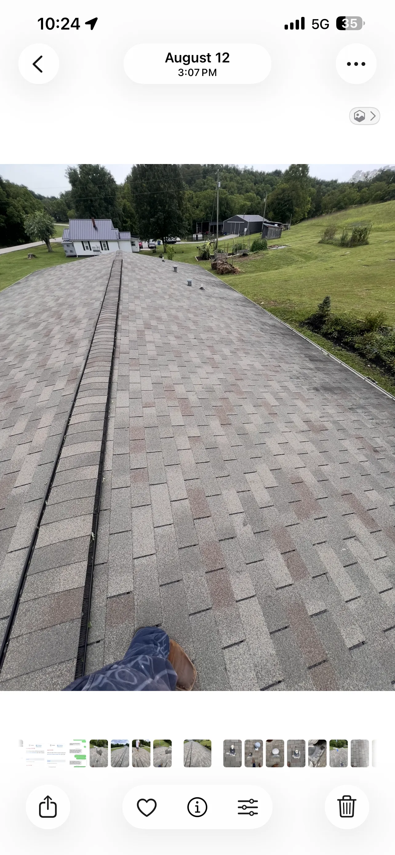 Completed roof repair showing repaired shingles blending into the surrounding existing roof surface with ridge vent visible