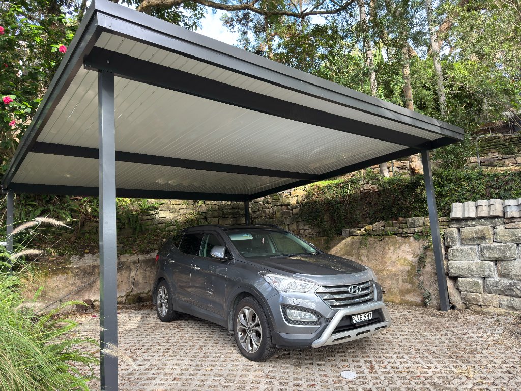 Custom carport with charcoal steel frame and ribbed ceiling panels