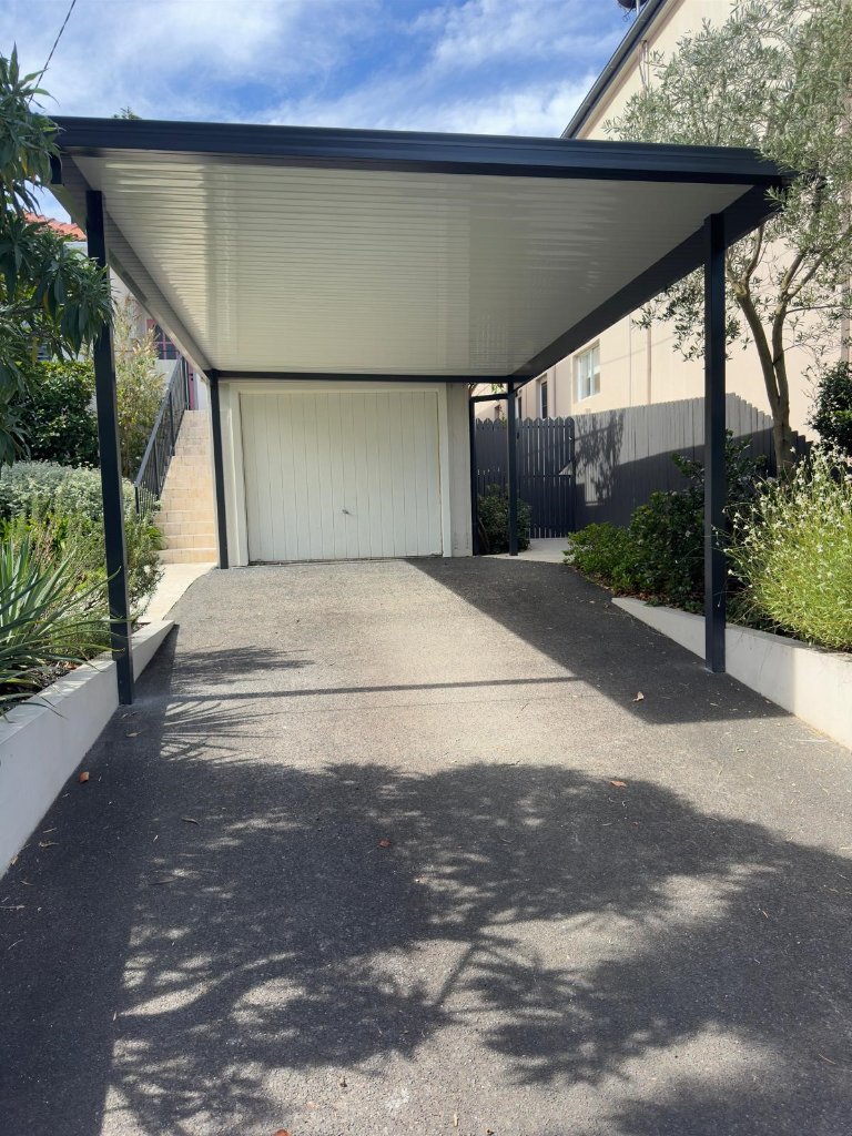 Single carport, Freshwater NSW — steel frame, Colorbond Ironstone, flat ceiling panel roof