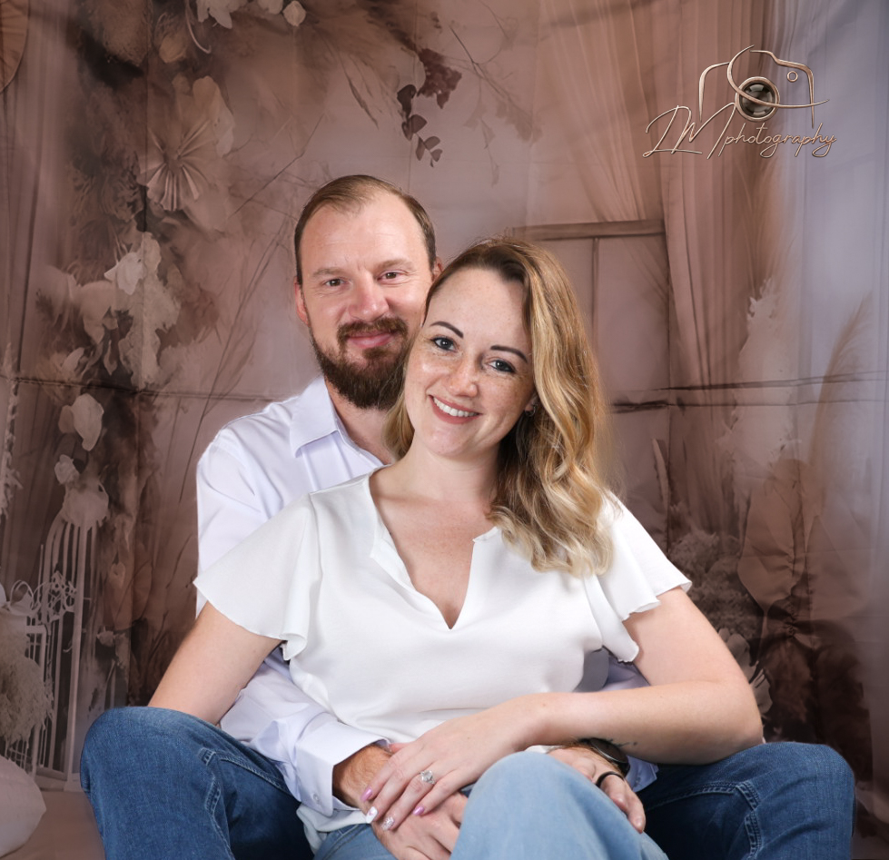 Couple portrait with vintage floral backdrop in studio