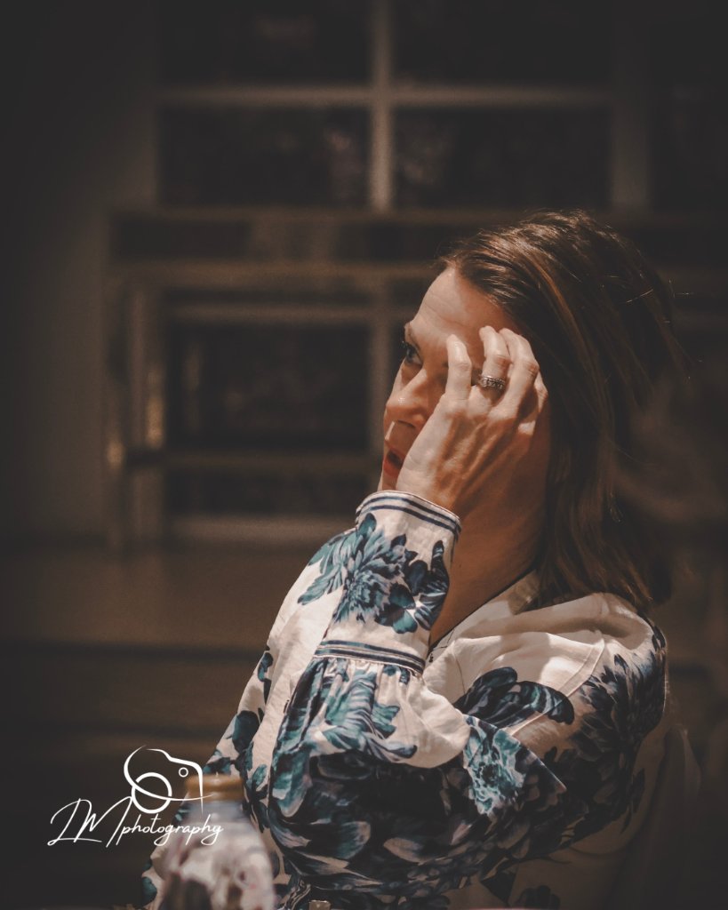 Intimate portrait of woman with window background and soft natural lighting