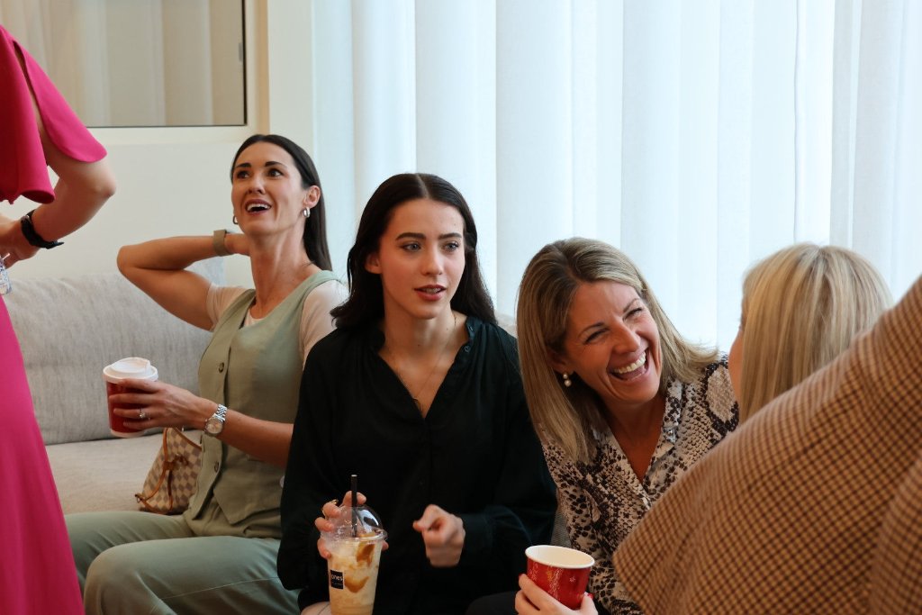 Group of women laughing and socialising at event