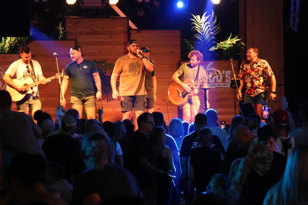 Full band performing live on stage at Baloo's Dubai with crowd