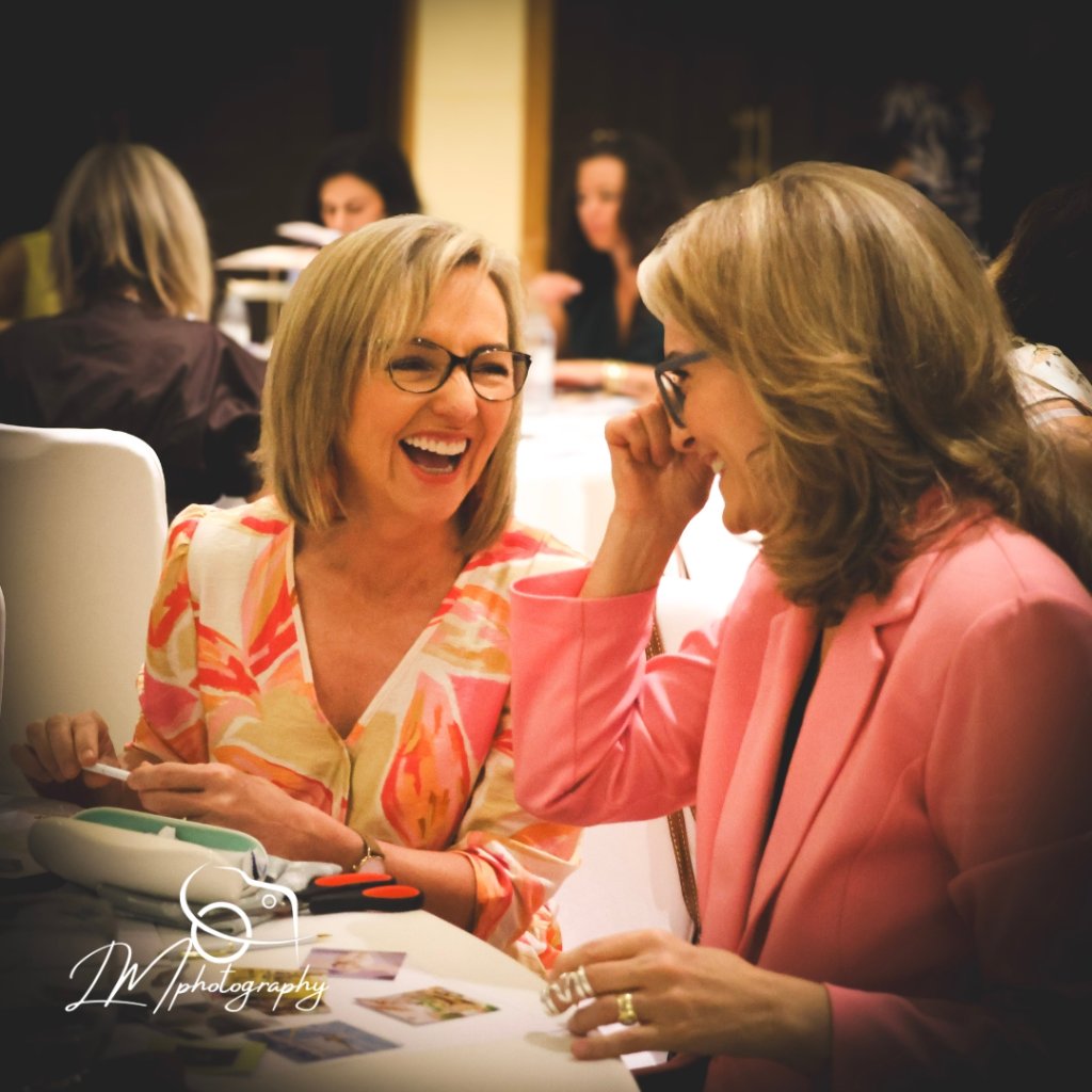 Women at corporate event table with warm lighting