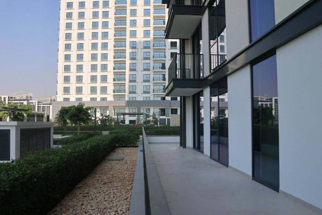Modern residential complex with landscaped courtyard, multi-story apartment building with contemporary architecture