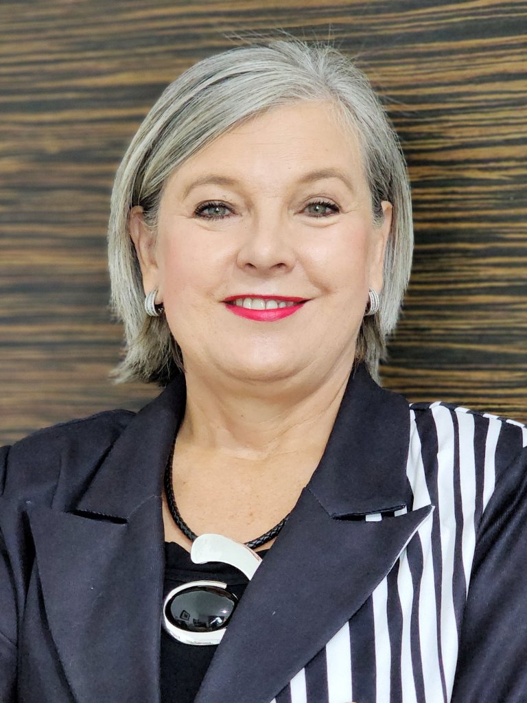 Professional headshot of woman in black and white blazer