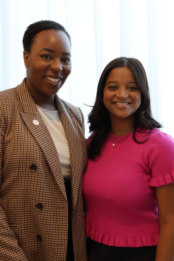Two women smiling together at event