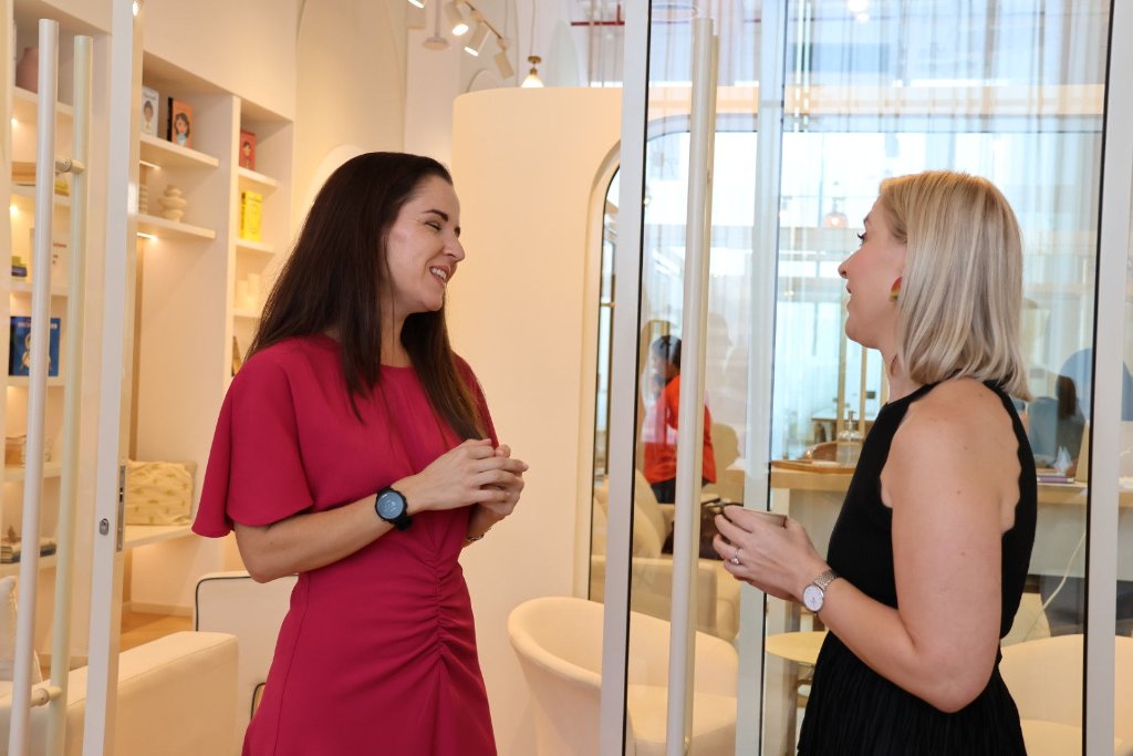 Two women in conversation at event venue Dubai