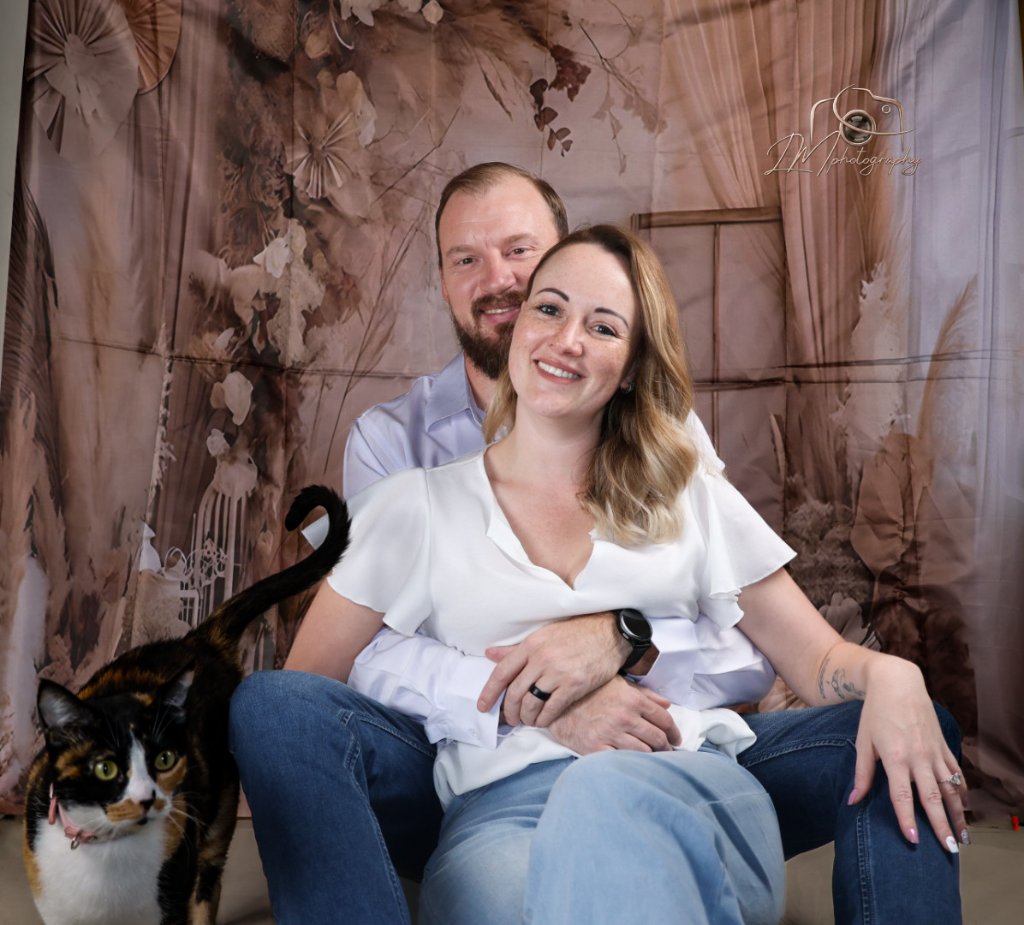 Couple with calico cat on vintage studio backdrop