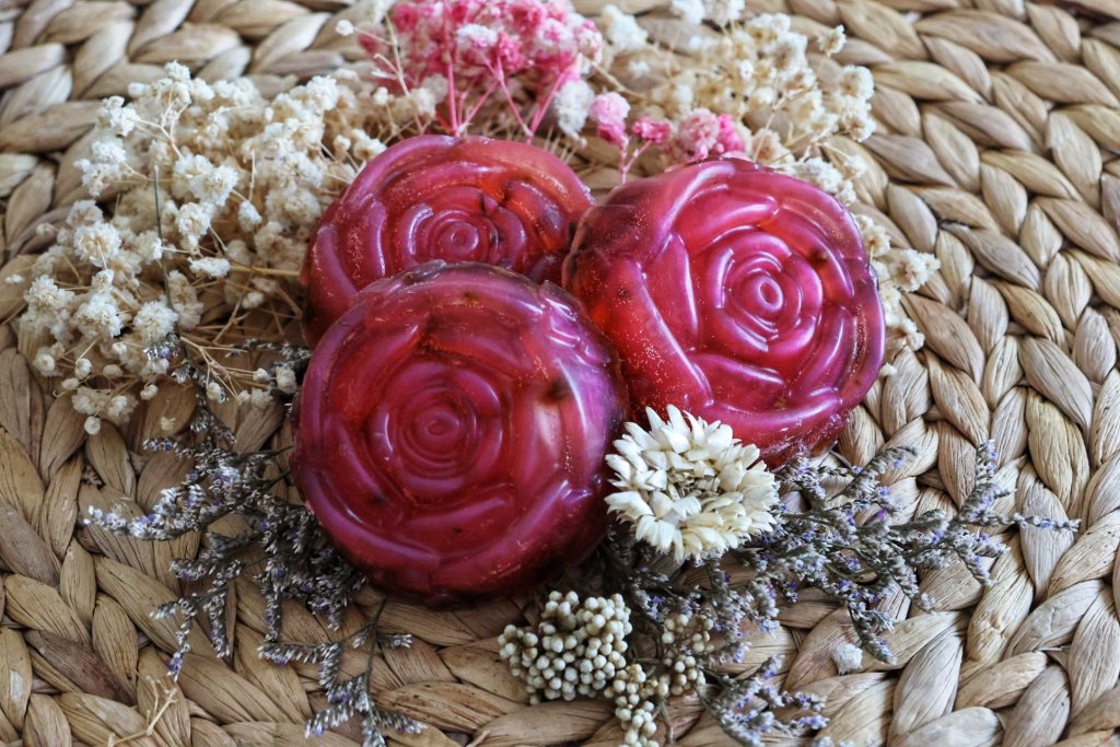 Red rose-shaped soap bars with dried flowers commercial product photography