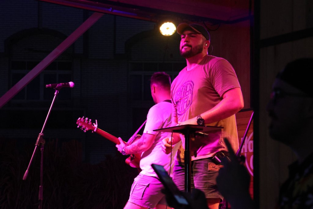 Close-up of performer on stage under pink stage lighting