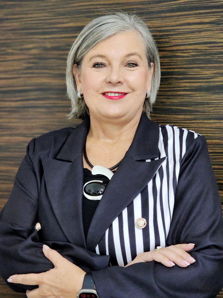 Corporate portrait of woman in striped blazer arms crossed