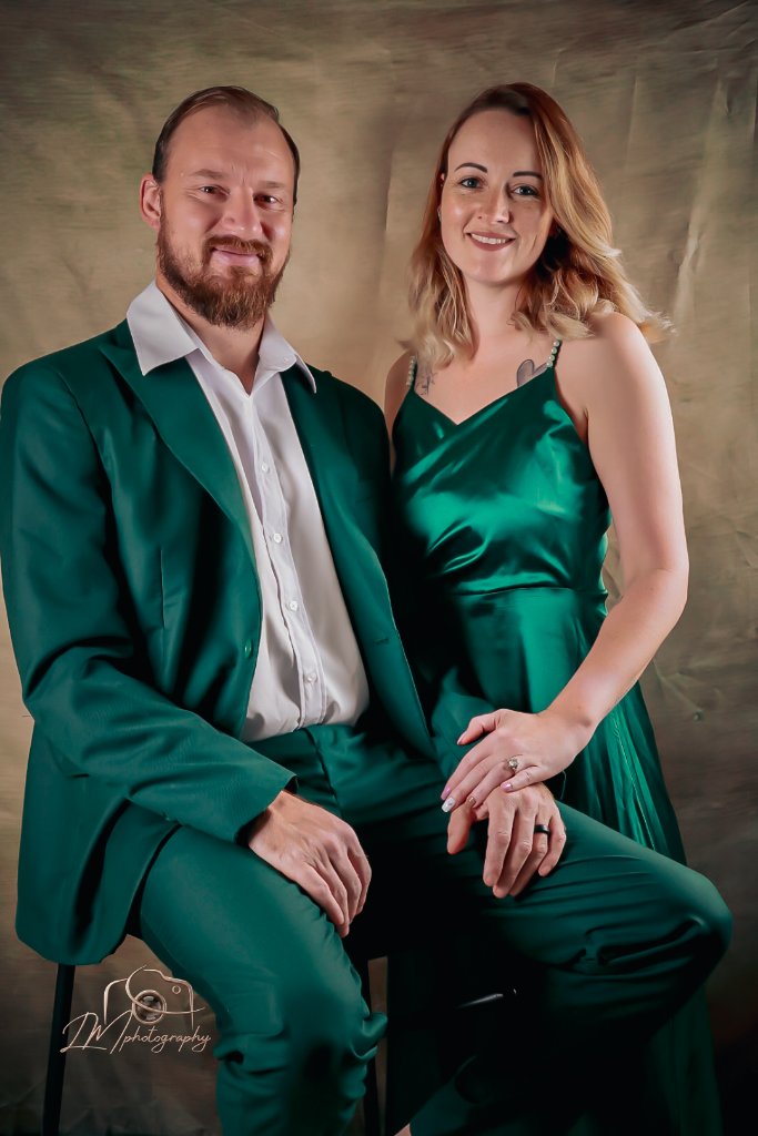 Couple in emerald green formal wear studio portrait