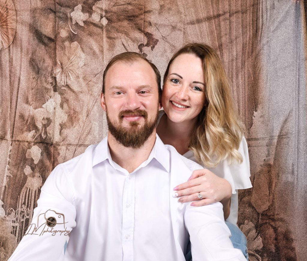 Couple portrait with warm bronze studio backdrop