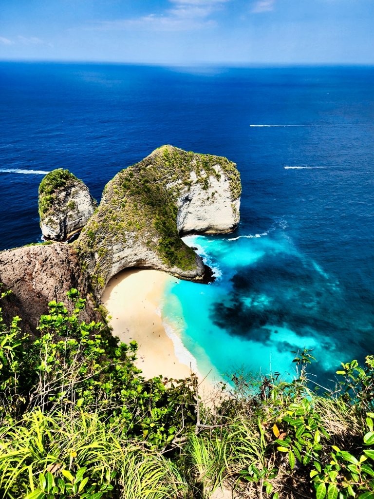 Iconic tropical beach cove with hidden white sand beach, rock formations and turquoise waters